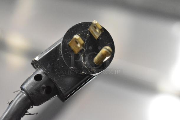 Close-up of a power plug for the True TD-50-18 stainless steel commercial back bar bottle cooler, 115 volts, 1 phase.