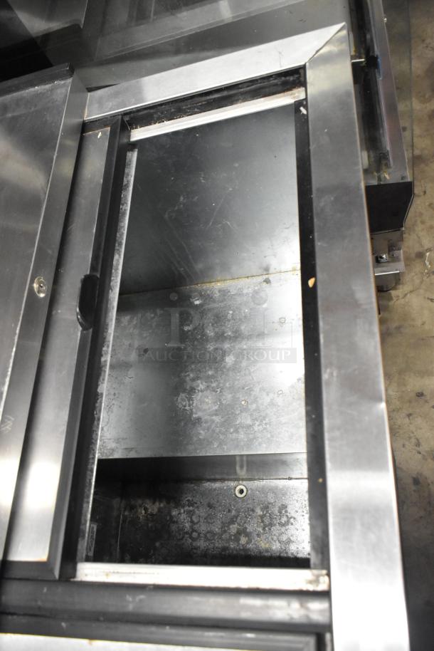 True TD-50-18 stainless steel back bar bottle cooler with 2 sliding lids. Slight wear visible. 115 volts, 1 phase.
