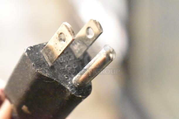 Close-up of a three-prong power plug showing wear, suitable for 115 Volts, compatible with Kool It KSM-36 cooler.