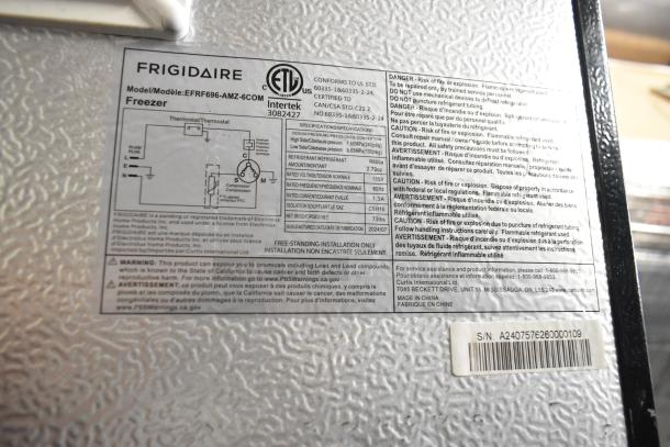 Frigidaire EFRF696-AMZ-6COM Stainless Steel Freezer tag showing model, voltage, and safety instructions.