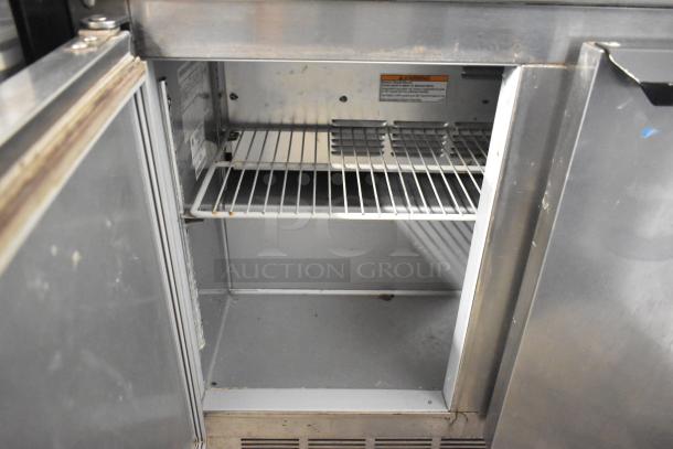Beverage Air UCR34Y stainless steel 2-door undercounter cooler, showing interior shelves, on commercial casters, 115V, 1 phase.
