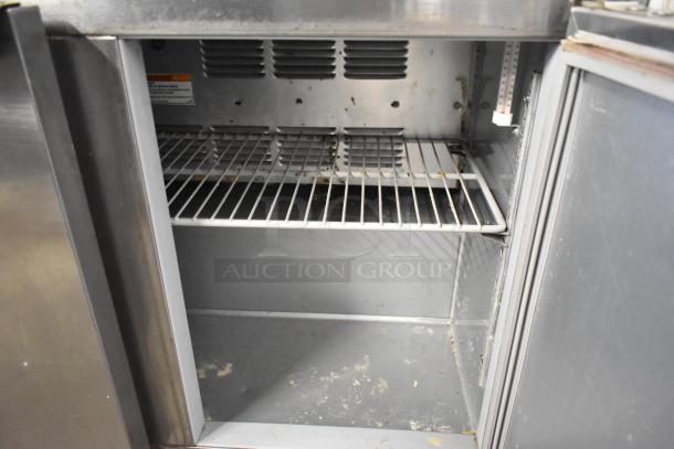 Beverage Air UCR34Y stainless steel 2-door undercounter cooler, on commercial casters, 115 volts, visible interior shelves.