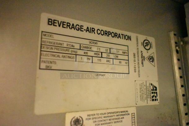 Beverage Air UCR34Y stainless steel 2-door undercounter cooler, model tag showing 115 volts, 1 phase, on commercial casters.