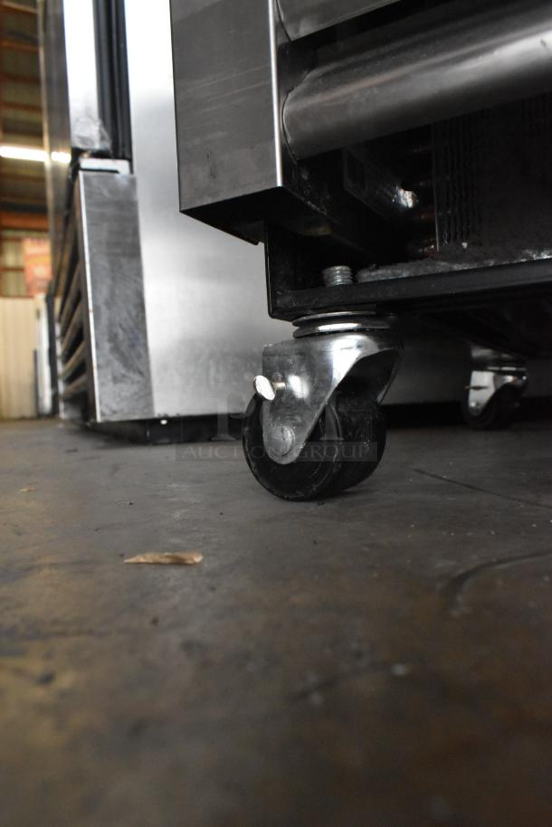 2024 True T-19F-HC stainless steel reach-in freezer on commercial casters. Visible caster detail.