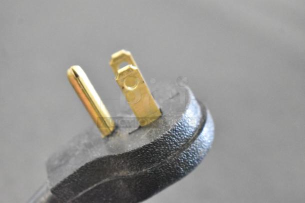 Close-up of a three-prong plug for the Imbera VRD41 2-door reach-in cooler, indicating 115 volts, 1 phase power connection.