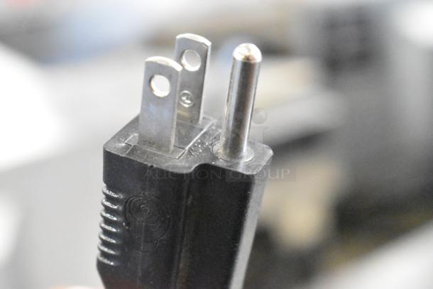 Close-up of a power plug for True GDM-06-LD commercial cooler, showing a three-prong design for 115 volts, 1 phase.