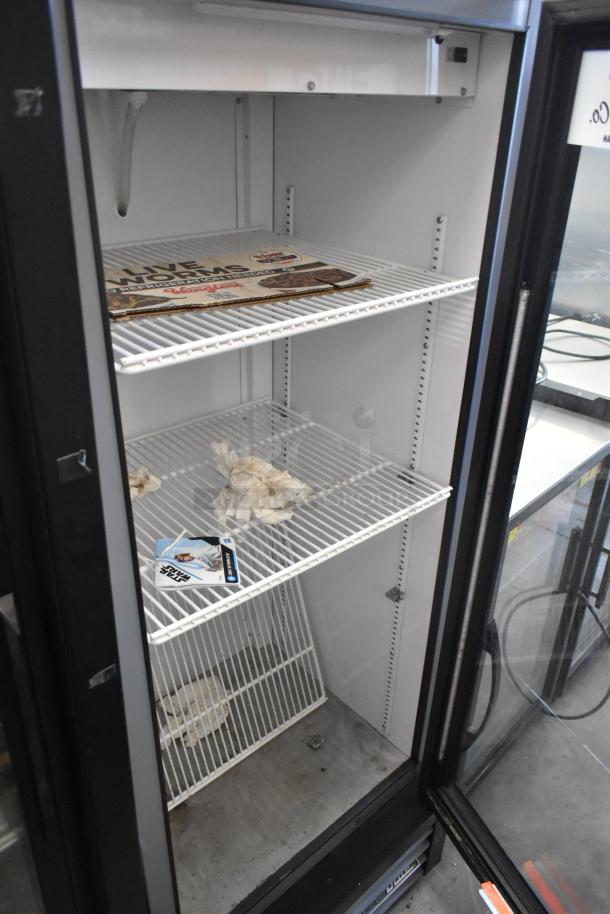 2024 True GDM-12-HC mini cooler merchandiser, metal frame, poly coated racks. Single door, 115V, 1 Phase. Interior shows some debris.