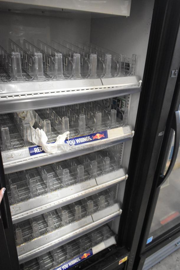 2022 True GDM-41SL-60-HC-LD 2-door cooler merchandiser with metal exterior and poly-coated racks, 115V, clean interior.