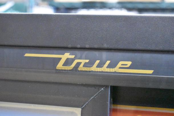 2022 True GDM-41SL-60-HC-LD metal cooler, poly racks, 2-door, 115V, commercial merchandiser, True logo detail.