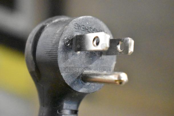 Close-up of a three-prong plug for the 2022 True T-19F-HC commercial freezer, highlighting electrical compatibility.