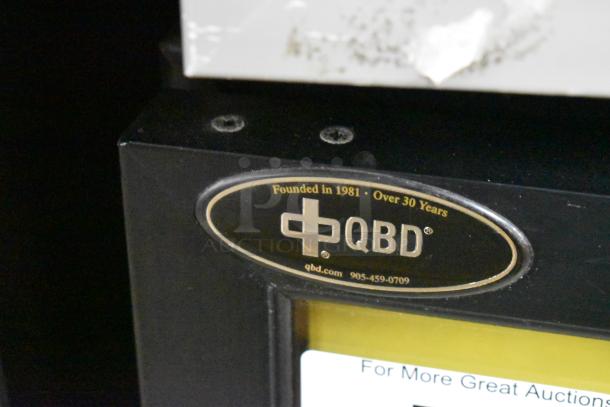 QBD DC6LP Metal Mini Cooler Merchandiser, 115 Volts, 1 Phase. Features QBD logo with contact info, established 1981.