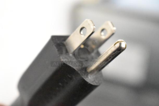 Close-up of a plug for the 2020 IDW G4-H0234B Cooler Merchandiser, 115 volts, 1 phase.