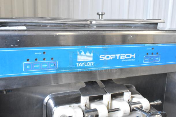 Taylor 754-27 stainless steel soft serve ice cream machine, dual flavor with twist, on commercial casters. Model 754-27.