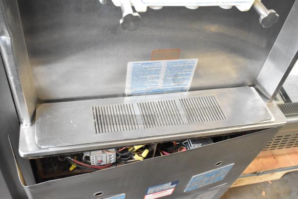 Taylor 754-27 stainless steel soft serve ice cream machine, 2 flavors with twist, on commercial casters; 208-230V, 1 Phase.