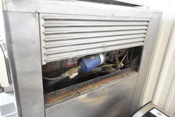 Taylor 754-27 stainless steel soft serve machine, commercial floor model, 2 flavor with twist, 208-230V, 1 phase, on casters.
