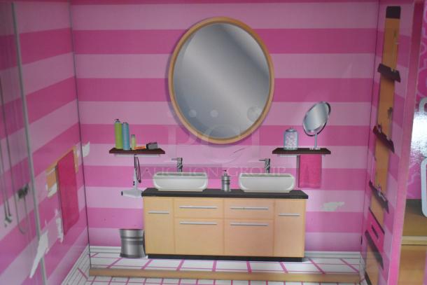 Doll playhouse bathroom with pink striped walls, double sinks, round mirror, shelves, and vanity set. In good condition.
