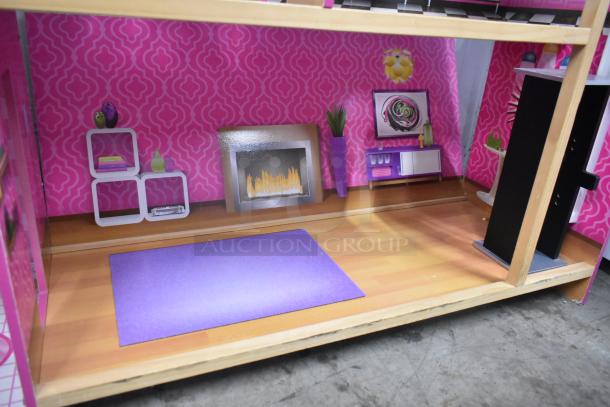 Doll playhouse featuring a room with pink patterned walls, faux fireplace, shelves, and a purple rug. Good condition.