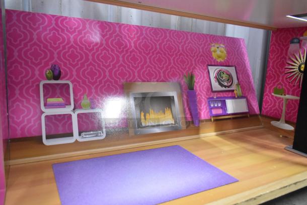 Doll playhouse with pink patterned walls, faux fireplace, modern décor, and purple rug. Good condition, ideal for play or display.