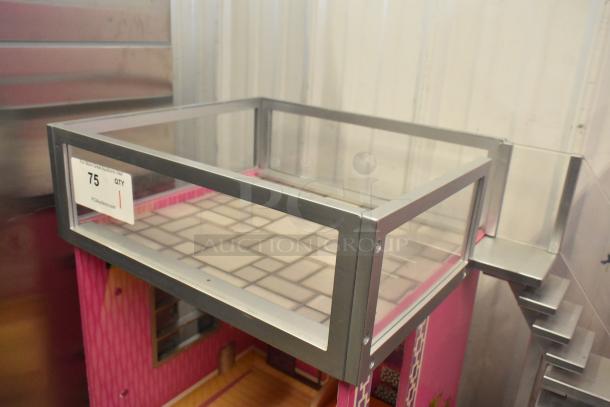Doll playhouse with pink interior and metal frame, features a rooftop terrace and stairs. Auction tag indicates lot 75.