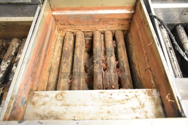 Pitco Frialator SSH75 Solstice Supreme gas fryer interior, showing wear and residue. Stainless steel, on commercial casters, 105,000 BTU.