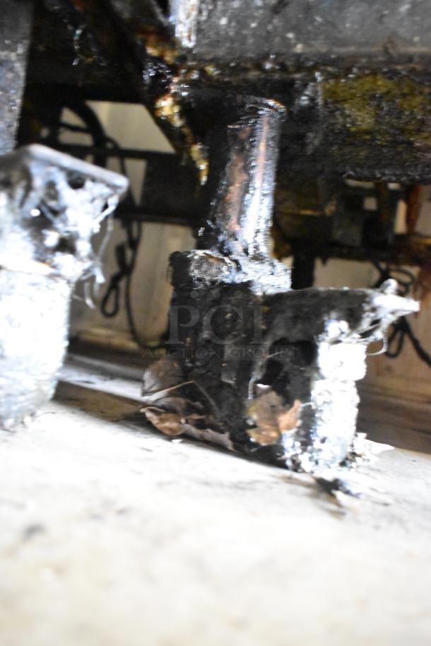 The image shows a close-up of the underside of a Pitco Frialator SSH75 Solstice Supreme deep fat fryer on casters.