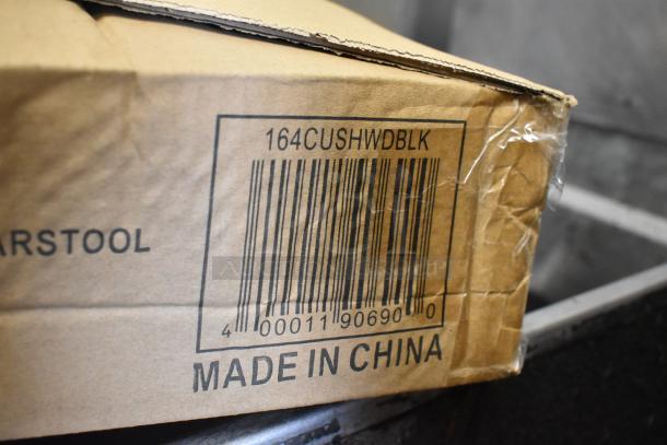 Cardboard box showing barcode and "164CUSHWDBLK" marking, indicating Lancaster bar stool, Made in China.