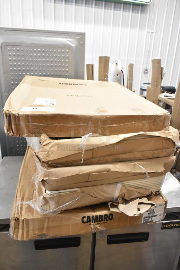 Stacked boxes labeled Cambro with visible wear, containing 5 new scratch and dent Cambro Camtread® and Bakers Mark trays.
