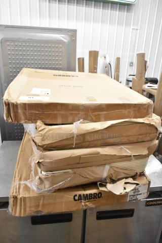 Stacked boxes labeled Cambro with visible wear, containing 5 new scratch and dent Cambro Camtread® and Bakers Mark trays.
