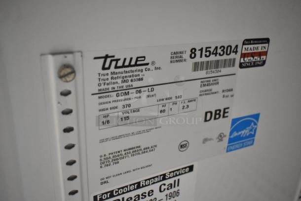 True GDM-06-LD metal mini cooler merchandiser label, showing model, voltage (115V), phase, and NSF, Energy Star certifications.