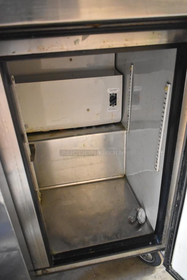 True TUC-36 stainless steel 2-door undercounter cooler, on casters, visible interior, 115V, 1 phase, shows some wear.