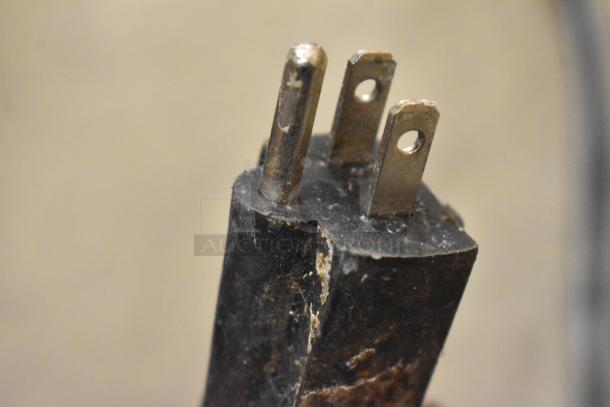 Close-up of a worn power plug from the NP-257 Stainless Steel Commercial Countertop Waffle Maker. 110 Volts, 1 Phase.