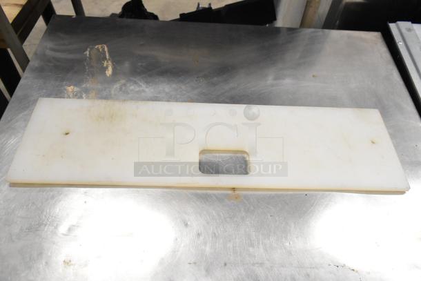 Two white cutting boards for Subway make line, rectangular with central handle hole, some surface wear visible.