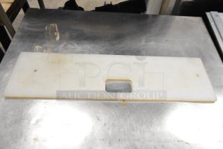 Two white cutting boards for Subway make line, rectangular with central handle hole, some surface wear visible.
