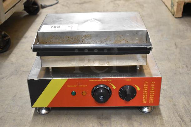 NP-520 stainless steel commercial waffle maker, 110V, features temperature and timer dials. Used condition with some surface wear.