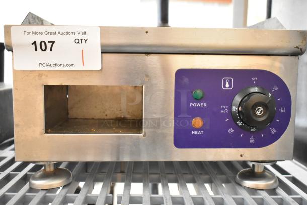 Stainless steel commercial electric flat top griddle, 110V, with adjustable temperature dial, power/heat indicators, and auction tag.
