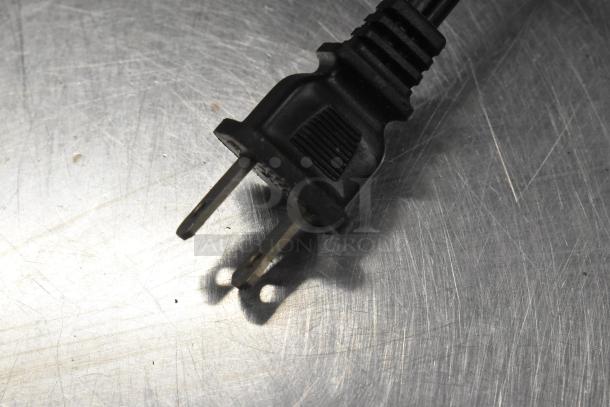 Power plug connected to Presto Eyersharp Knife Sharpener, displayed on a metallic surface.