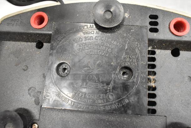 Close-up of a Presto Eversharp knife sharpener bottom, featuring model details and caution text visible on a worn surface.
