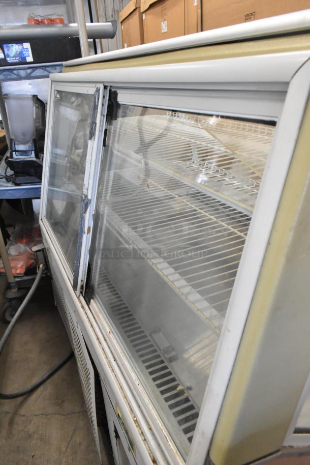 Turbo Air TB-5R metal bakery case with curved glass, commercial casters, 115V, 1 phase, showing moderate wear.