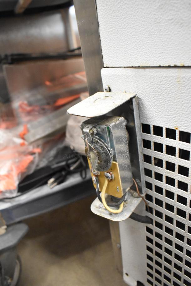 Turbo Air TB-5R refrigerated bakery case, metal, curved glass, commercial casters, 115 volts, visible wear.