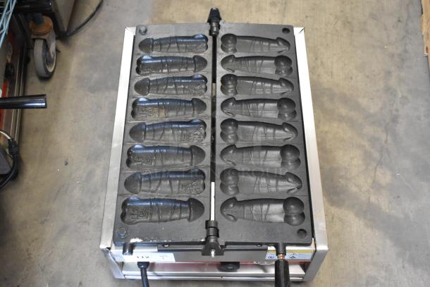 A Piece of Gayke NP-229 stainless steel commercial countertop specialty waffle maker, 110 volts, with unique mold design.