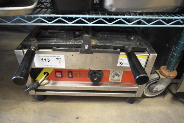 A Piece of Gayke NP-229 stainless steel waffle maker, commercial countertop, 110V, 1 Phase, shows wear, with control knobs and handles.