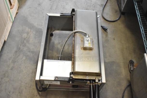 A Piece of Gayke NP-229 Stainless Steel Commercial Waffle Maker, 110 Volts, 1 Phase. Some wear visible, electrical cord attached.