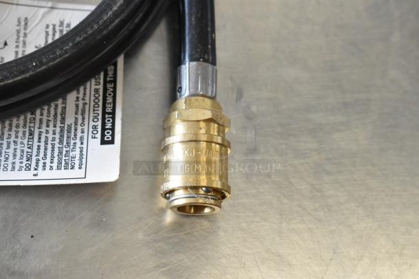 Rubber gas hose with brass connector, marked "MAX 1/4" PSIG." Appears in good condition, suitable for outdoor use.