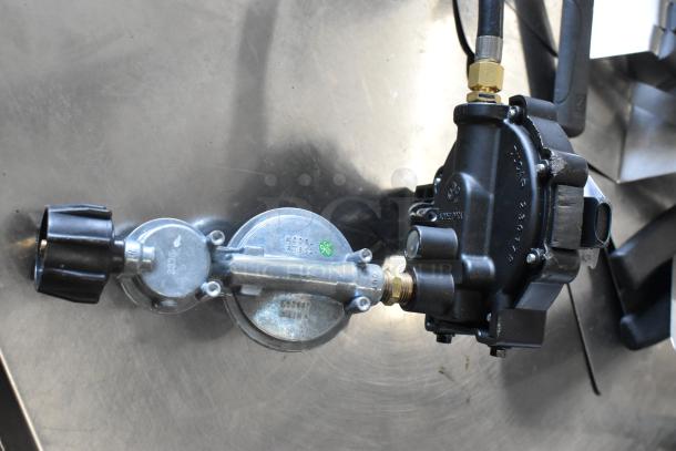 Gas hose with attached regulator, Model RT362. Features brass fittings, black and metal components. Appears in good condition.