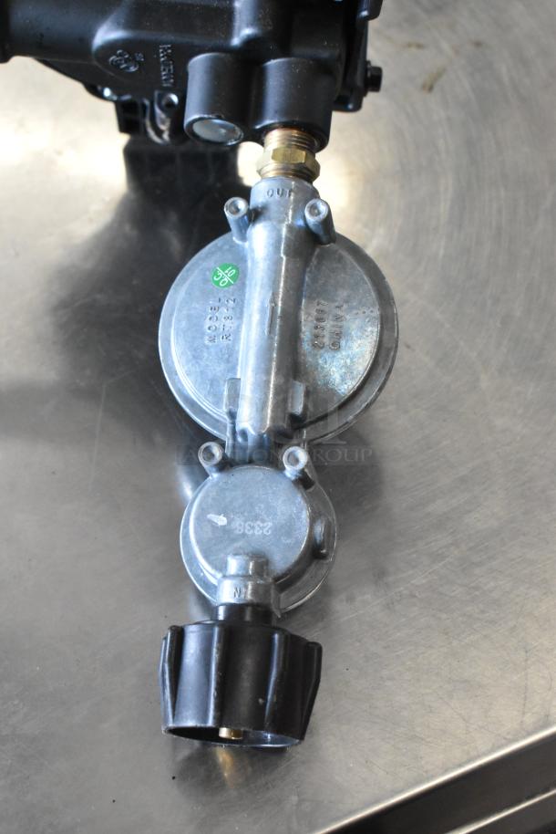 Gas hose regulator, Model R1832, with brass connector and black control knob, in good condition.