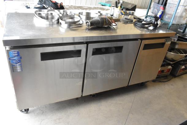 Dukers DUC72R stainless steel 3-door undercounter cooler, commercial casters, model label visible. 115V, 1 phase.