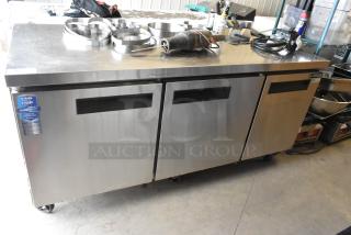 Dukers DUC72R stainless steel 3-door undercounter cooler, commercial casters, model label visible. 115V, 1 phase.
