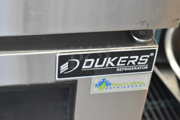 Dukers DUC72R stainless steel commercial cooler, 3 doors, on casters. Features "Natural Refrigerant" label.