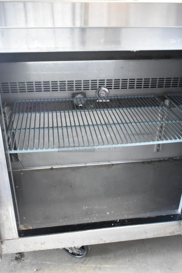 Dukers DUC72R stainless steel commercial undercounter cooler, 3 doors, on casters, interior shelf, 115V, 1 phase, used condition.