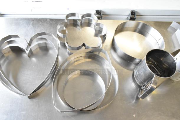 Metal baking tools set including heart and flower-shaped cake collars, used stainless steel condition.